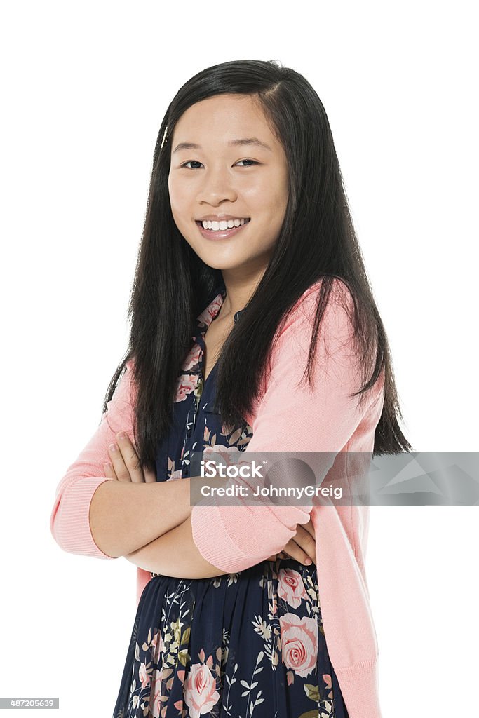 Happy Chinese Girl Smiling Portrait of happy teenage girl standing arms crossed. White background. Chinese. 14-15 Years Stock Photo