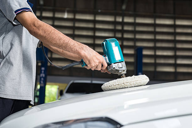 istock Car polishing series : Worker waxing white car 487206336