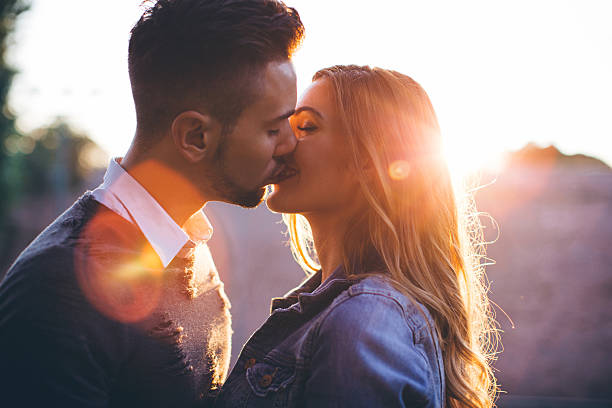 istock Young couple kissing in park. 487206344