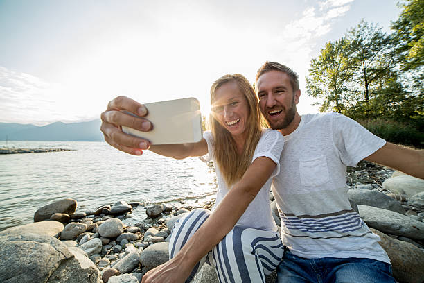 istock Two young adults taking selfie portrait 487206464