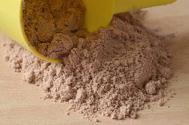 istock Chocolate protein powder spilled from yellow scoop 487206526