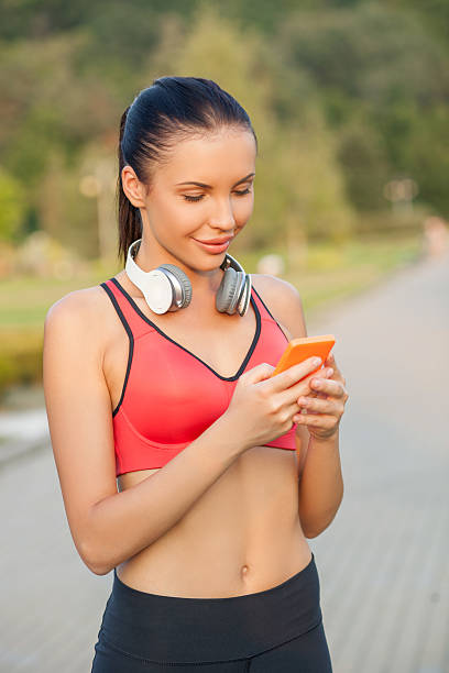 istock Attractive young sport girl is jogging with modern technologies 487206804
