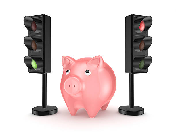 istock Pink piggy bank around traffic lights. 487206828
