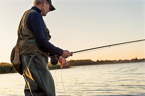 istock Fly Fisherman Patiently Waiting For a Bite 487207062