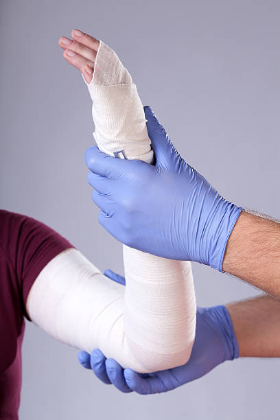istock Doctor holding bandaged arm 487208341