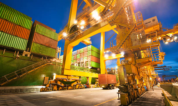 istock Cargo ship in the harbor at sunset . 487209586