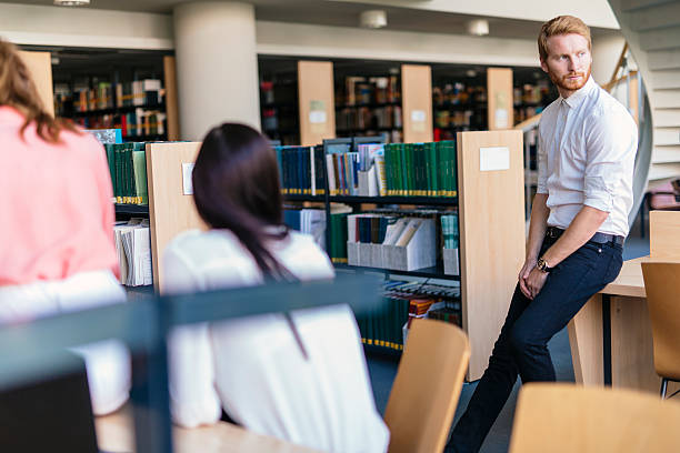 istock Group of young people educating themselves in a library 487209822