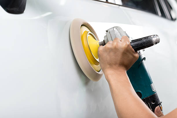 istock Car polishing series : Worker waxing white car 487210136
