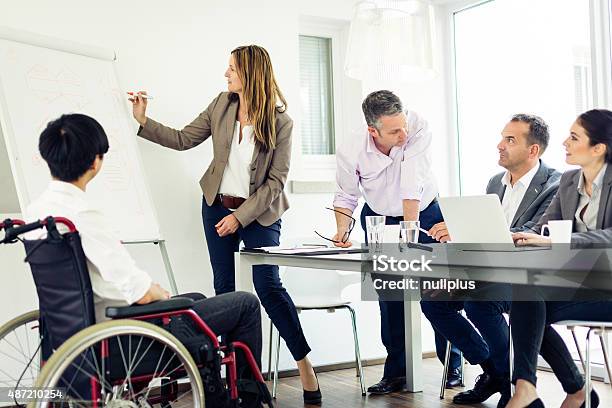 Business Team Having A Meeting Stock Photo - Download Image Now - Whiteboard - Visual Aid, Business Meeting, Disability