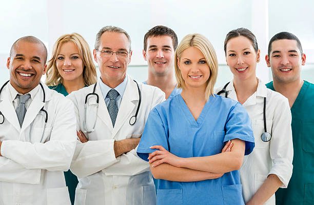 istock Team of happy doctors and surgeons looking at camera. 487210290