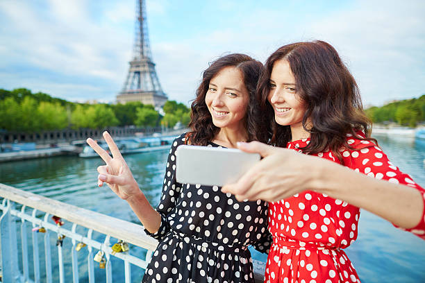 istock Beautiful twin sisters taking selfie in front of Eiffel Tower 487213724