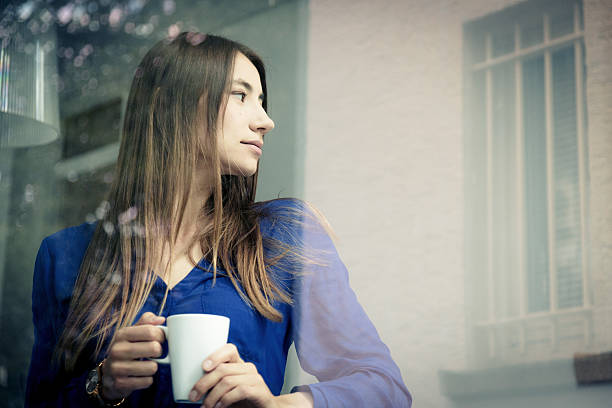istock young woman having a cup of coffee 487214210
