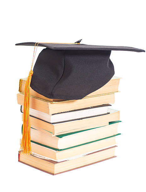 istock Graduation Hat with books isolated on white 487214212