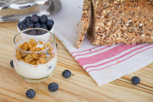 Healthy Breakfast: yogur with blueberries and corn cereals and homemade wholemeal bread