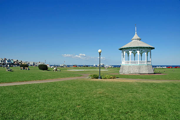 istock Gazebo on green grass lawn with blue skies,  Cape Cod 487221684