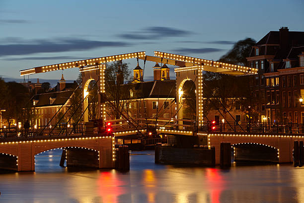 istock Amsterdam, Netherlands - Drawbridge in the evening 487222111