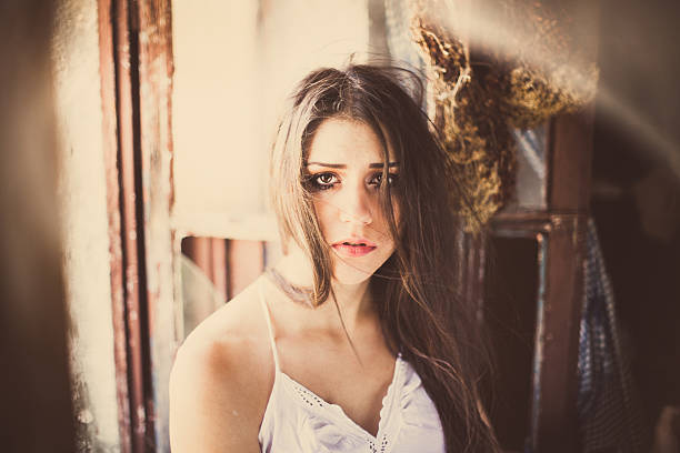 Brunette crying sad abused woman portrait in a old house