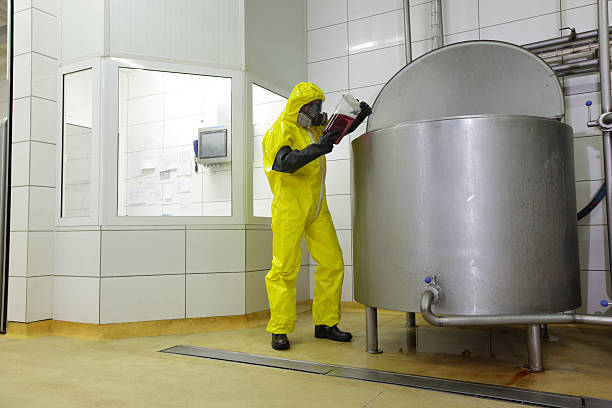 technician in protective uniform working in industrial environment technician in protective uniform working in industrial environment mixing vat stock pictures, royalty-free photos & images