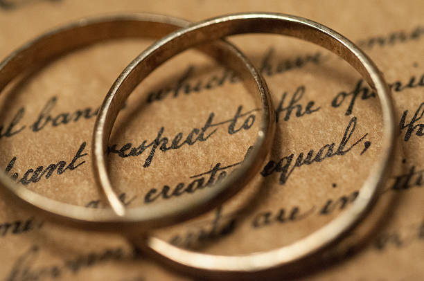 istock Wedding rings on the US Constitution 487223027