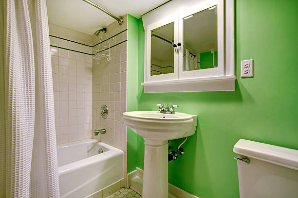 istock Green bathroom with white tile trim 487223235