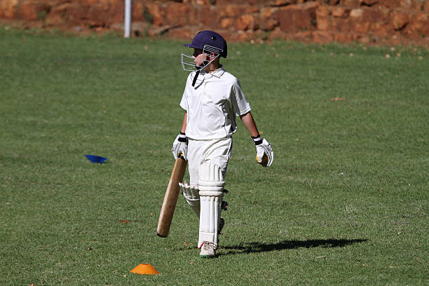 istock Cricket boy walking n to bat 487225099