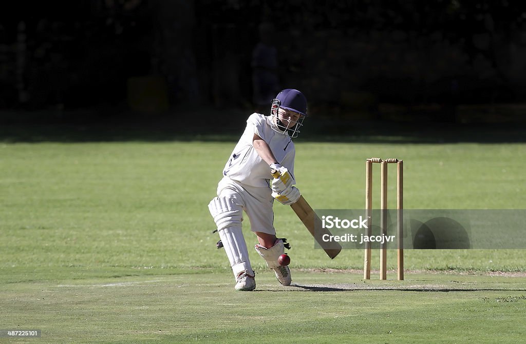Young boy playing cricket shot A young boy is playing a big cricket shot with a lot of confidence. Sport of Cricket Stock Photo
