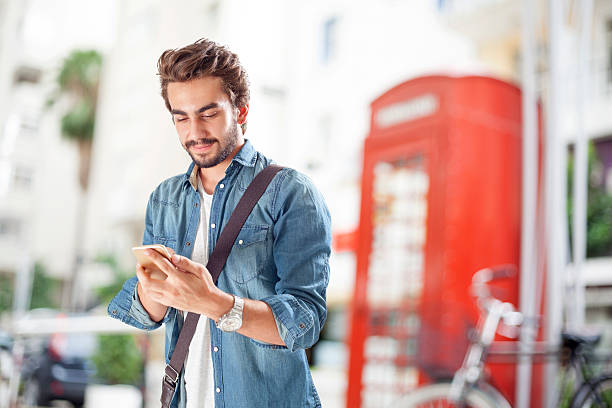istock Young man using mobile phone in street 487225298