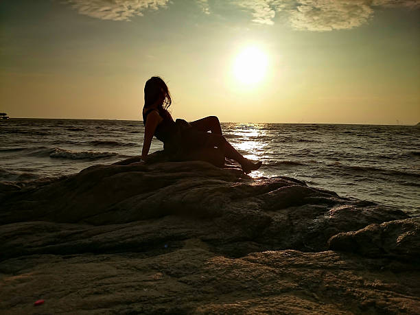istock Girl lying in Front of a Sunrise 487228770