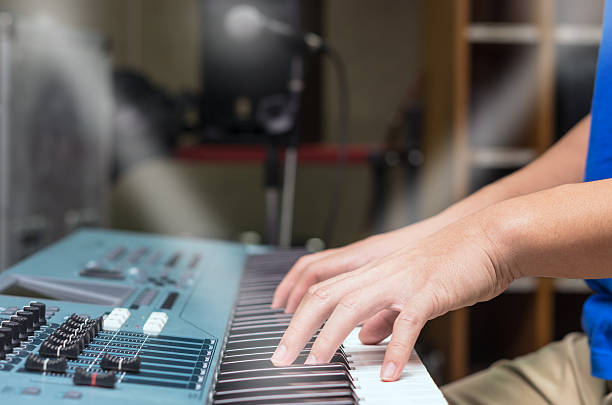 istock hands playing the keyboard or piano, focus middle finger 487230838