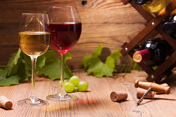 istock Glasses of red and white wine, served with grapes 487233350