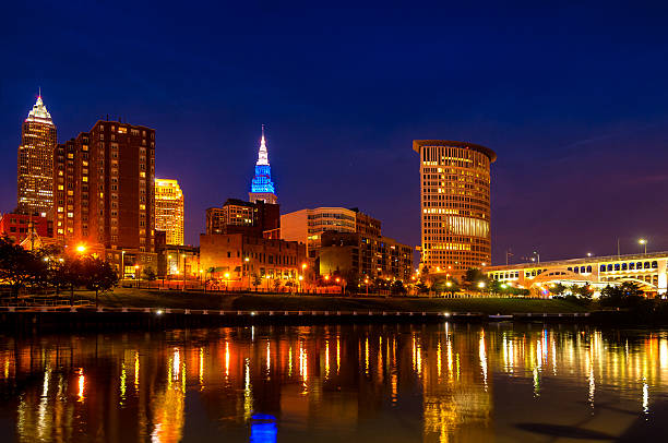 Cleveland blue hour Downtown Cleveland Ohio as seen from the west bank of the Cuyahoga River at blue hour terminal tower stock pictures, royalty-free photos & images