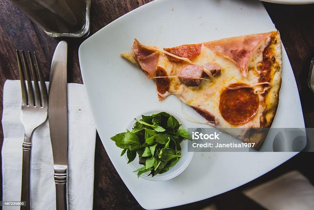 food Pizza with vagetables vegetable pizza with folk, knife, plate, glass cup, and a tissue 2015 Stock Photo