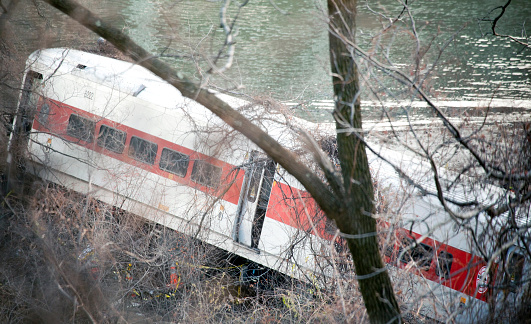 Bronx, New York, USA - November 29, 2013: A Metro North train derails and crashes near the water.