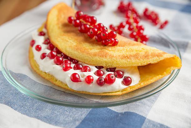Sweet omelette with clotted cream and currant berries
