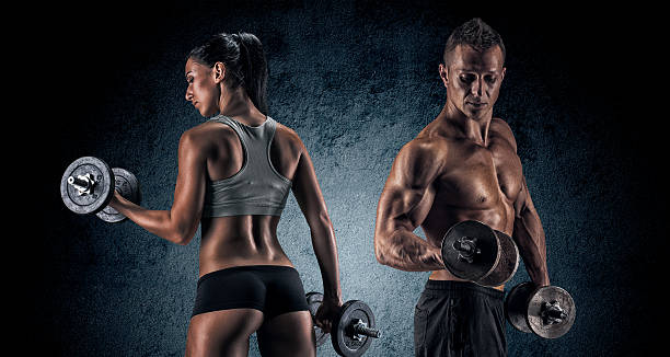 istock Athletic man and woman with a dumbells. 487241536
