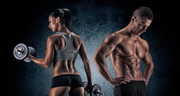 istock Athletic man and woman with a dumbells. 487241540