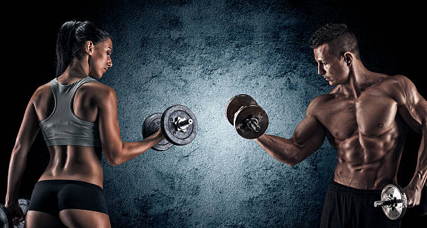 istock Athletic man and woman with a dumbells. 487241570