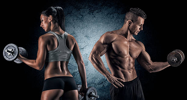 istock Athletic man and woman with a dumbells. 487241572