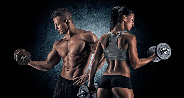 istock Athletic man and woman with a dumbells. 487241574