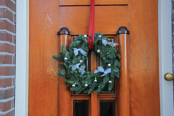 istock Classic christmas wreath with decorations on a door 487242588
