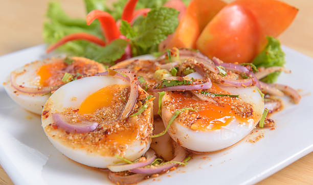 istock thai food spicy minced boiled egg salad on white dish 487243544