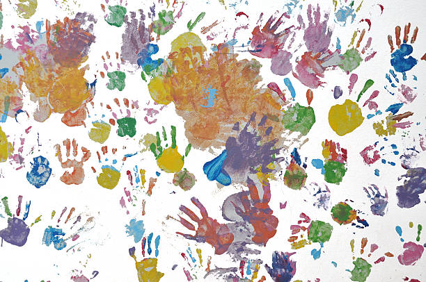 istock Colorful child handprint on white wall. 487243934
