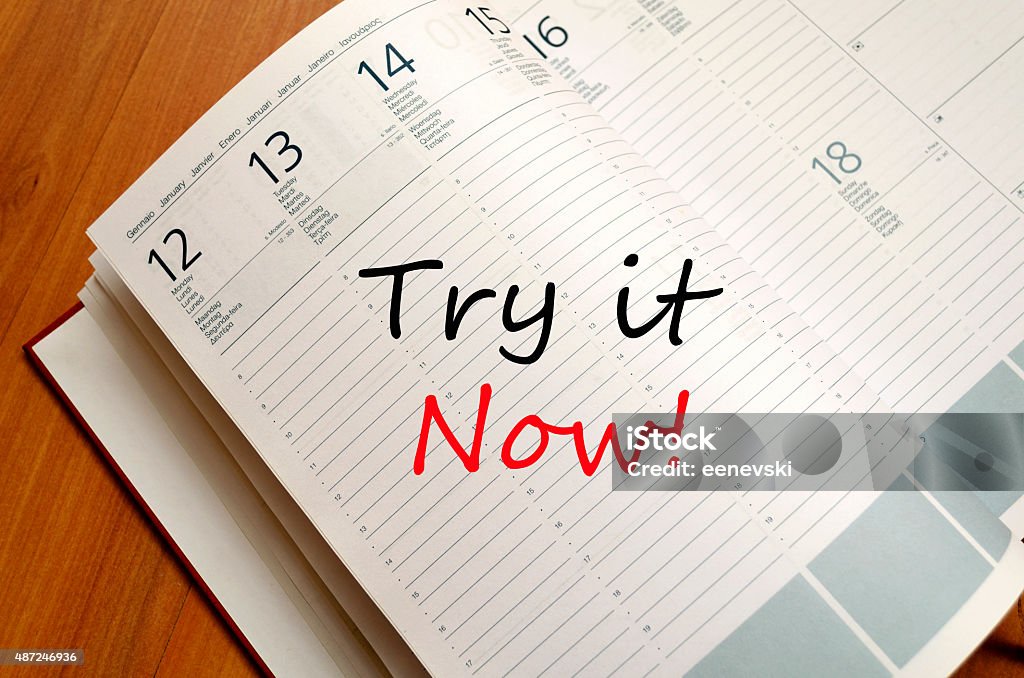 Try it now concept Business Notepad on wooden table Try it now concept 2015 Stock Photo