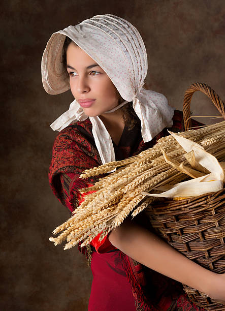 Victorian peasant girl Reenactment image of a victorian peasant girl holding a basket bonnet hat stock pictures, royalty-free photos & images
