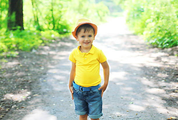 istock Happy little boy child in hat walking 487250278