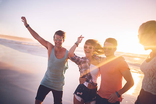 istock Happy teenage friends on beach 487250507