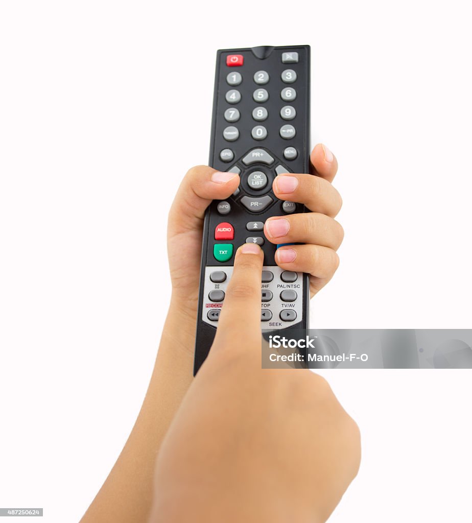 kid pressing the remote control hand of a child holding television remote isolated on white background Remote Control Stock Photo