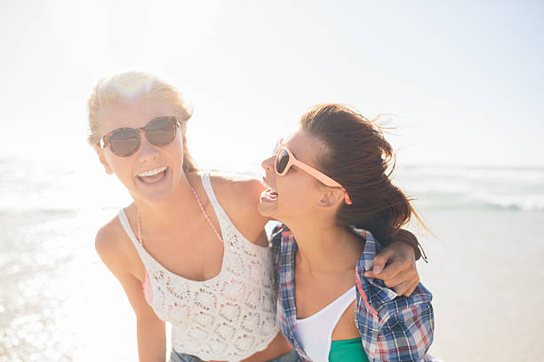 istock Girls laughing on beach 487250775