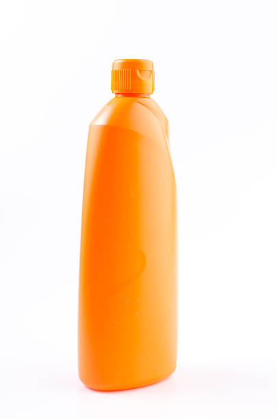 istock Orange cleaning bottle on isolated white background 487251359