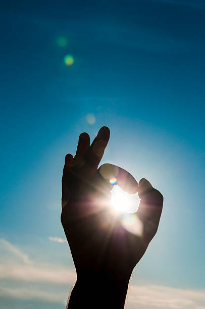istock Sun in the hand on blue sky 487253396